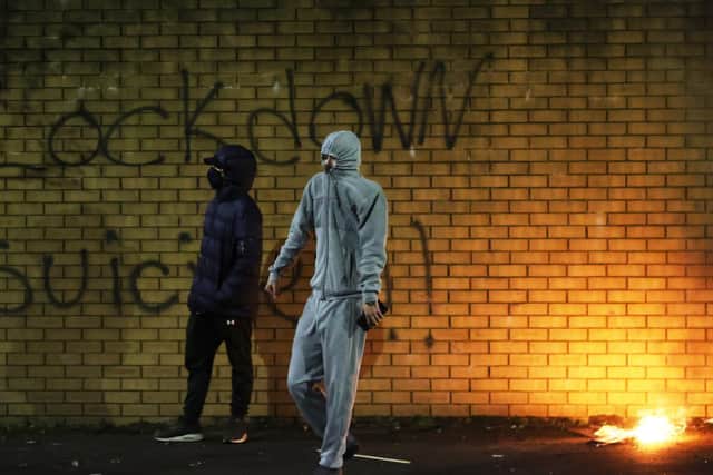 A man carrying bricks in Belfast during further unrest in Belfast. (Photo: PA)