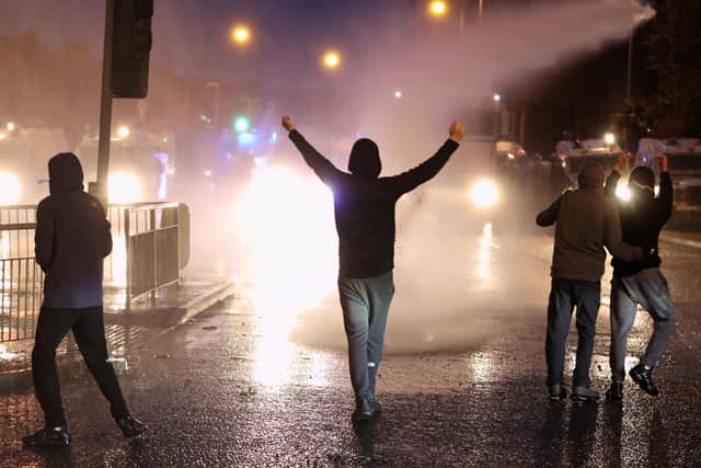 The PSNI use a water cannon on youths on the Springfield road, during further unrest in Belfast on Thursday. Photo: Liam McBurney/PA Wire