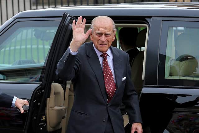 Prince Philip waves to well-wishers during a visit to Crumlin Road jail in June 2014. 

Picture - Kevin Scott / Presseye