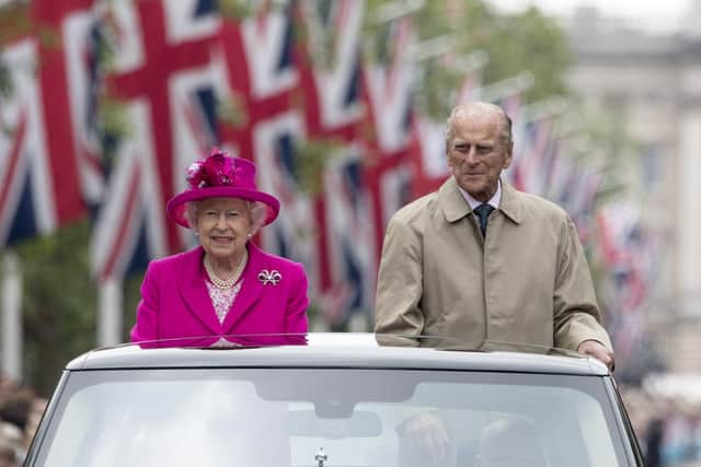 File photo dated 12/06/16 of Queen Elizabeth II and the Duke of Edinburgh making their way down The Mall in an open topped Range Rover, during the Patron's Lunch in central London in honour of the Queen's 90th birthday. The Duke of Edinburgh has died, Buckingham Palace has announced. Issue date: Friday April 9, 2020.. See PA story DEATH Philip. Photo credit should read: Arthur Edwards/The Sun/PA Wire