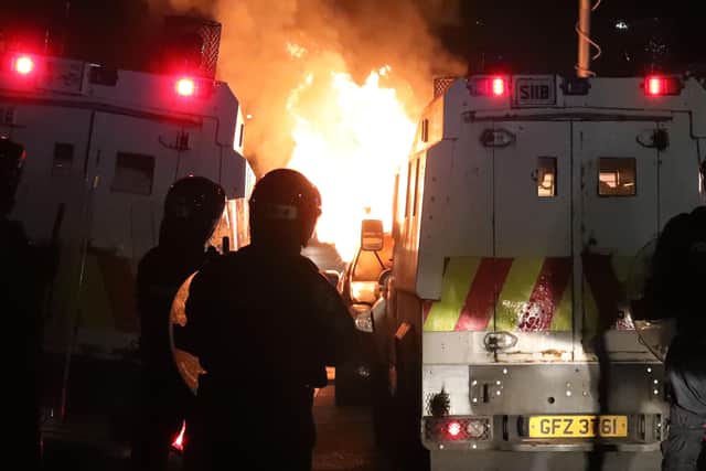 PSNI deal with a burning hijacked car in the Tiger's Bay area of North Belfast last night. 

Photo by Kelvin Boyes  / Press Eye.