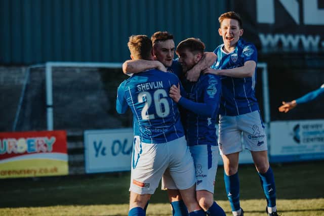 Stephen O’Donnell is mobbed by his team-mates after his winner against Warrenpoint Town. PICTURE: David Cavan