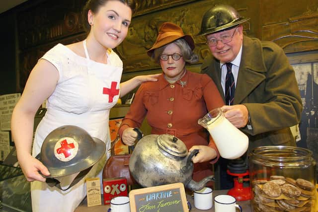 NI War Memorial staff members Jenny Haslett and the late Bill Porter are pictured in authentic wartime uniforms. PHOTO: Peter O'Hara