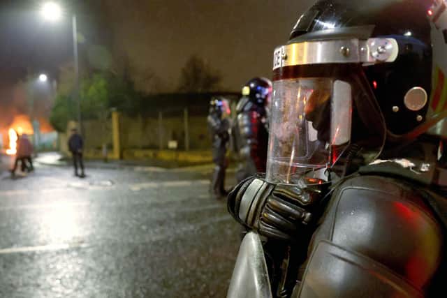 PSNI riot squad officers try to keep Nationalist and Loyalists apart at Lanark Way interface in Belfast during a riot on Wednesday night.