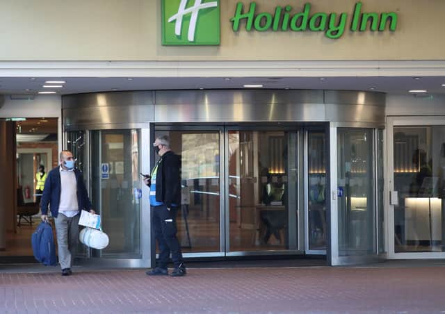 A guest leaves the Holiday Inn hotel near Heathrow Airport, London, after completing their 10-day stay at the government-designated quarantine hotel. There will now be a hotel quarantine in Northern Ireland for arrivals from red list countries. Photo:  Jonathan Brady/PA Wire