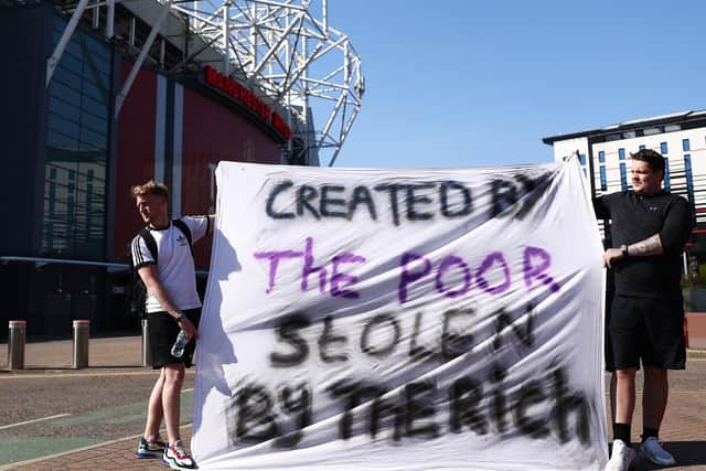 Football fans opposing the European Super League outside Old Trafford in Manchester on Monday.