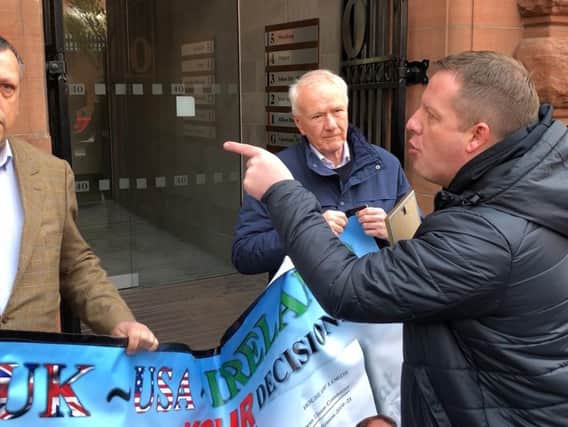 Gareth McCord (right), the brother of a paramilitary murder victim, interrupts LCC chairman David Campbell (left) and former Ulster Unionist MLA and UKIP NI leader David McNarry (centre) during a small loyalist protest against Brexit's Northern Ireland Protocol outside the Irish Secretariat offices in Belfast.