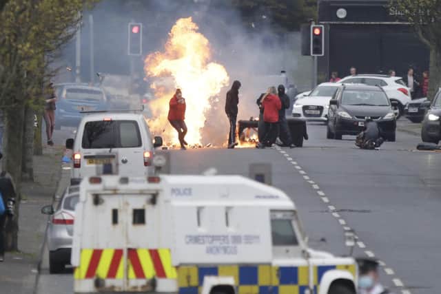 Loyalist rioters burn a barricade on Lanark Way, Belfast on Monday night before they attacked police with missiles.