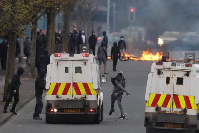 PSNI vehicles and loyalist protesters during further unrest on Lanark Way in Belfast. Picture date: MondayApril 19, 2021.