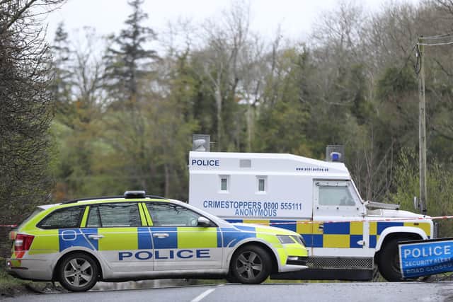 PSNI vehicles block a road during a security operation which has been ongoing since Monday on the Ballyquin Road after a viable explosive device was found close to the home, in a rural area close to Dungiven, of a member of the Police Service of Northern Ireland in Co Londonderry. Pic: Niall Carson/PA Wire