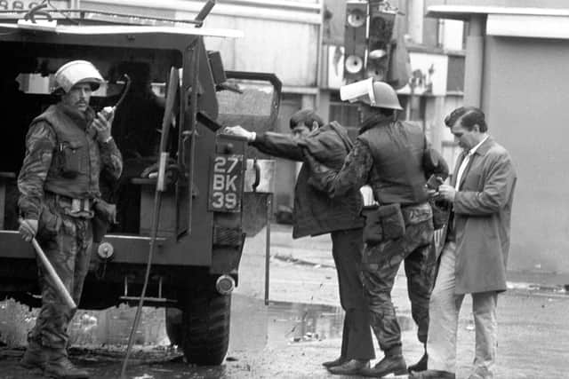 Troops conduct street searches of people entering Londonderry in the early day of the NI Troubles.
