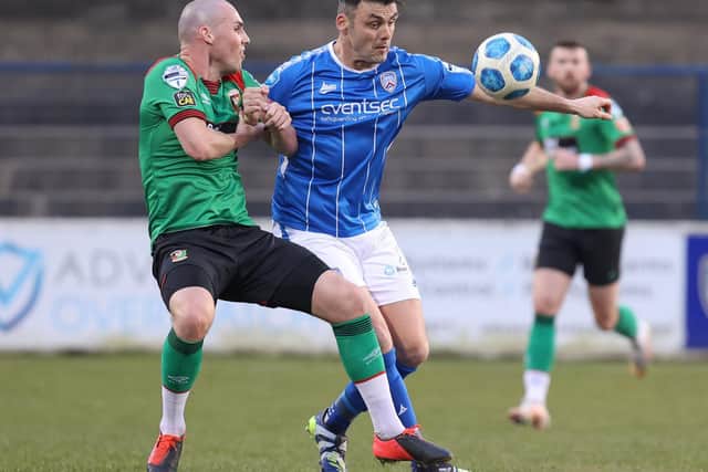 Coleraine striker Eoin Bradley tussles with Glentoran’s Luke McCullough