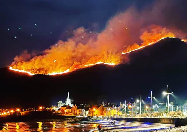 Photo taken with permission from the Twitter feed of @DeeJayDready showing a huge gorse fire spreading across the Mourne Mountains in Co Down, as seen from Newcastle, Co Down. The fire in the Slieve Donard area has been ongoing since the early hours of Friday morning, with up to 60 firefighters and 12 appliances battling the blaze. Issue date: Saturday April 24, 2021.