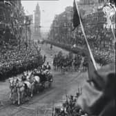 The royal procession as it rides from the docks past the Albert Clock through cheering crowds towards Belfast City Hall in June 1921. From Pathé film reel