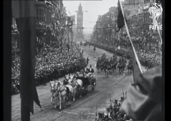 The royal procession as it rides from the docks past the Albert Clock through cheering crowds towards Belfast City Hall in June 1921. From Pathé film reel