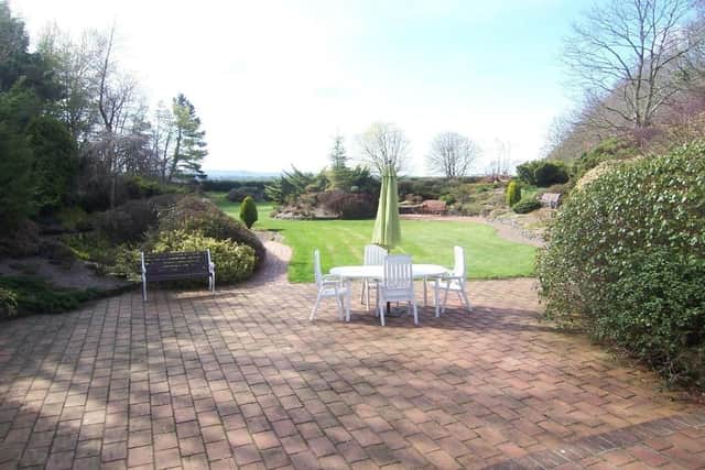 The mature gardens and plot extends to approximately 2 1⁄2 acres comprising an array of landscaped rockeries, flowerbeds, feature pond and various patio/bbq areas