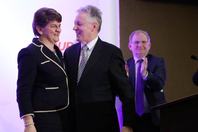 December 17, 2015: New leader of the DUP Arlene Foster pictured alongside Peter Robinson, just after her takeover was announced; applauding in the background is longtime DUP chairman Lord Morrow