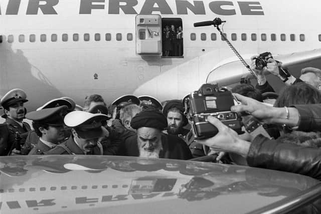 Photograph taken on 1 February 1979 at Tehran airport of revolutionary leader Ayatollah Ruhollah Khomeini, centre, surrounded by journalists after leaving the Air France Boeing 747 jumbo that flew him back from exile in France to Tehran. Picture: Gabriel Duval/AFP
