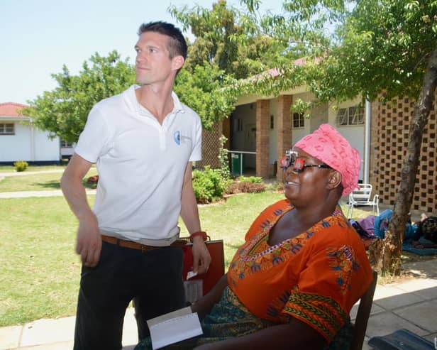 Andrew Spence with a patient in Zimbabwe