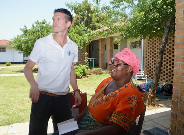 Andrew Spence with a patient in Zimbabwe