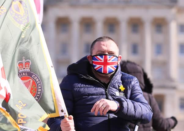 Protesters pictured at Carson's statue at Stormont in east Belfast where they were showing their support for British Army veterans who were being prosecuted over killings during the Troubles . 

Picture by Jonathan Porter/PressEye