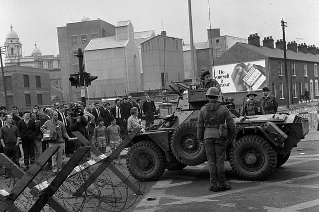 A military armoured car and barbed wire road block in Divis Street, Belfast.