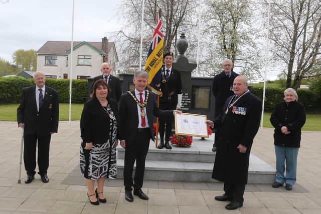 Cllr Mark FiElding Mayor of Causeway Coast and Glens Borough Council and his wife Mayoress Phylis presented a plaque to mark the formation of Dervock RBL which celebrated 100 years to George Black Chairman during the laying of a wreath by the Mayor in Dervock at the war memorial to mark VE Day on Saturday. Picture Kevin McAuley/McAuley Multimedia