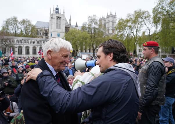 Former veterans minister Johnny Mercer with Dennis Hutchings at a 'Respect our Meterans' march in Parliament Square, central London.