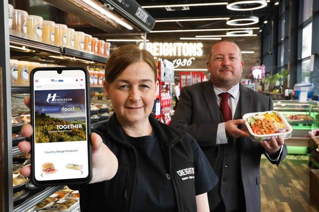Elaine Williams, Development Manager with Creightons Group helps Chris Palmer, E-Commerce lead with Hendersons celebrate the company’s Akeneo leadership award