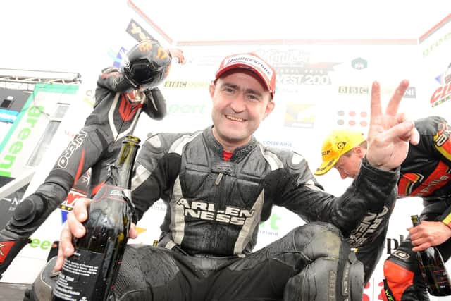 An emotional Paul Robinson celebrates his first ever win at the North West 200 in the 125c race in 2010.