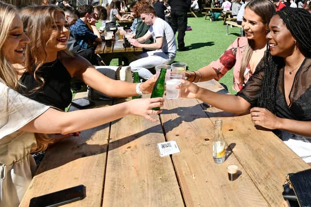 Customers enjoy a drink outdoors at the Botanic Inn, Belfast after the recent reopening of outdoor hospitality