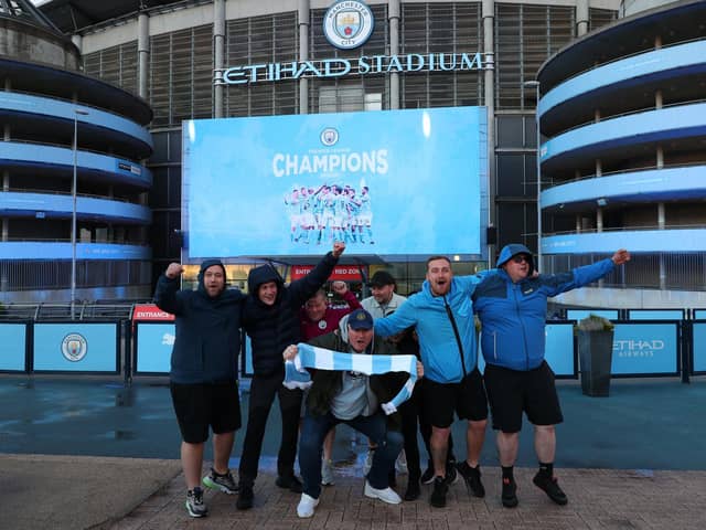 Manchester City fans celebrate at the Etihad Stadium, after Manchester City were crowned Premier League champions following Manchester United’s home defeat to Leicester