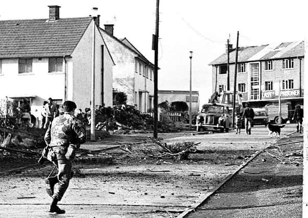 A soldier on the scene of a booby-trap explosion in Ballymurphy, 14/10/82