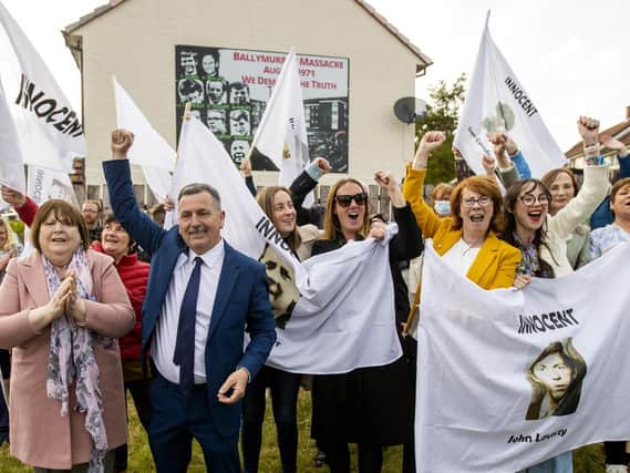 The families of the victims and supporters waving white flags with the words "innocent" on them, in Ballymurphy, just hours after a coroner ruled that the 10 people killed in the west Belfast shootings involving British soldiers in Ballymurphy in August 1971 were entirely innocent.