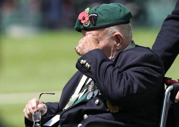 A D-Day veteran wipes his eyes during a Royal British Legion's Service of Remembrance.
