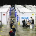 People wait in line to receive their Covid-19 vaccine in the SSE Arena, Belfast.