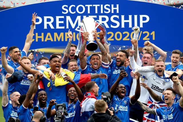 Rangers' James Tavernier lifts the trophy as he celebrates winning the Scottish Premiership at Ibrox Stadium, Glasgow.