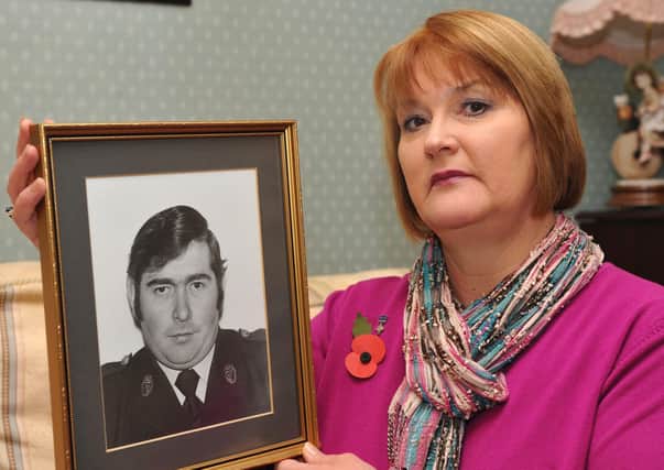 Phyllis Carrothers holds a photograph of her late husband Dougie
