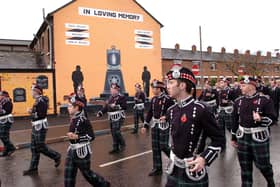A flute band marches past a UDA mural at a Remembrance Day ceremony in Sandy Row, Belfast, in May 2007. Picture: Justin Kernoghan/Photopress Belfast