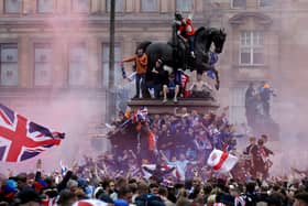 Rangers fans celebrate winning the Scottish Premiership in George Square. Photo: Andrew Milligan/PA Wire.