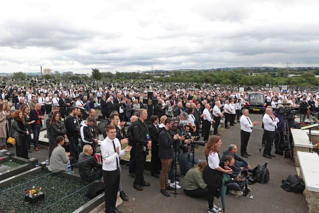 A crowd listens to former Sinn Fein president Gerry Adams speak during the funeral of senior Irish Republican and former leading IRA figure Bobby Storey at Milltown Cemetery in west Belfast. PA Photo. Picture date: Tuesday June 30, 2020. See PA story FUNERAL Storey Photo credit should read: Liam McBurney/PA Wire