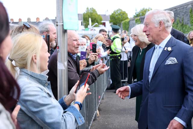 The Prince of Wales and the Duchess of Cornwall meeting well wishers during a visit to Bangor Market where they walked around and meeting stall holders at the open-air market. Picture date: Wednesday May 19, 2021.