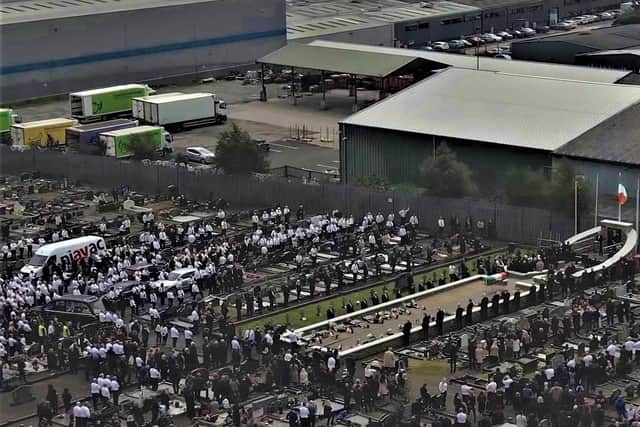 Aerial footage of mourners in Milltown listening to a Sinn Fein oration