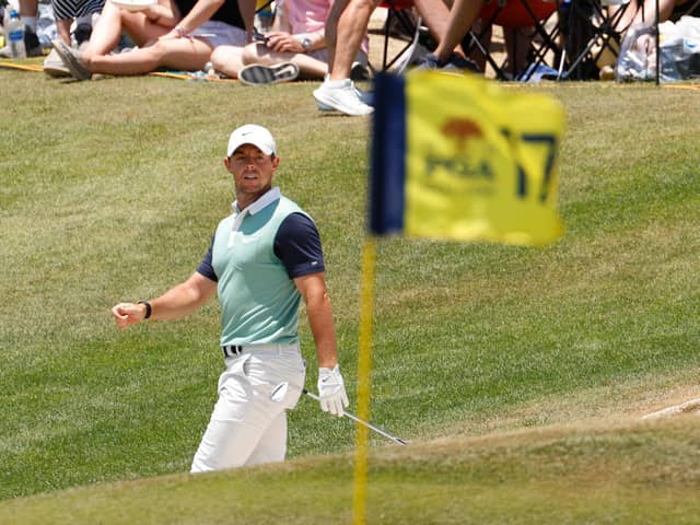 Rory McIlroy watches his shot on the 17th green