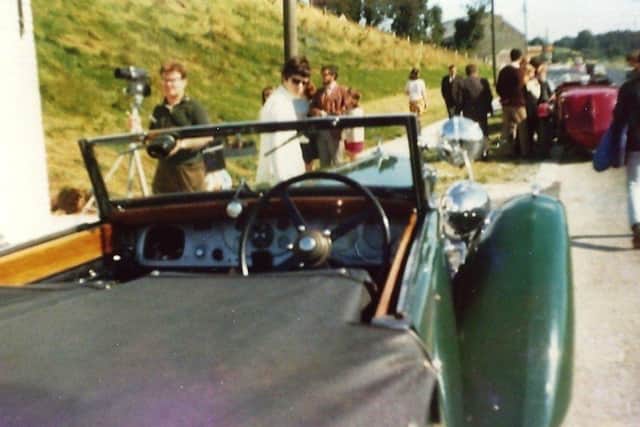 Race fans surround the cars before Ards TT