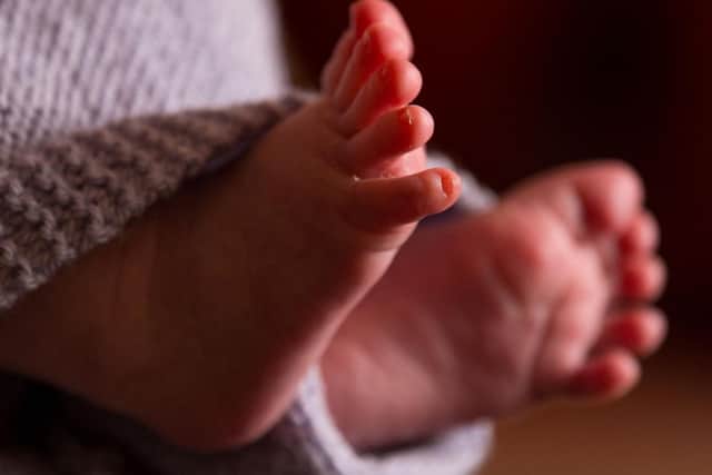 The feet of a new baby wrapped in a blanket