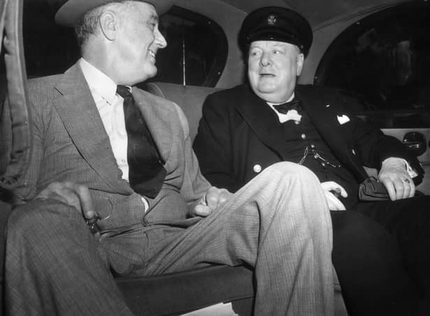 British Prime Minister Winston Leonard Spencer Churchill (1874 - 1965) with Franklin Delano Roosevelt (1882 - 1945) 32nd President of the United States, seated in a car on their way to the White House in Washington to discuss the Allied Victory in North Africa.   (Photo by Topical Press Agency/Getty Images)