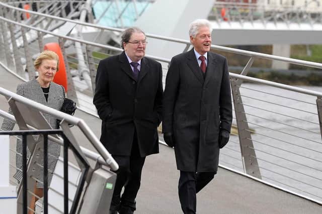 John and Pat Hume with President Bill Clinton cross the Peace Bridge