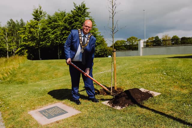 Mayor Cllr Jim Montgomery plants Covid memorials.