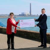 Ian Luney, commercial director of EP UK investments, presenting a cheque for £14,000 to Jackie McCaughey, MindWise area manager for housing support services.